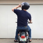 Here's What It Means When You See A Biker Point Their Thumb At Their Helmet